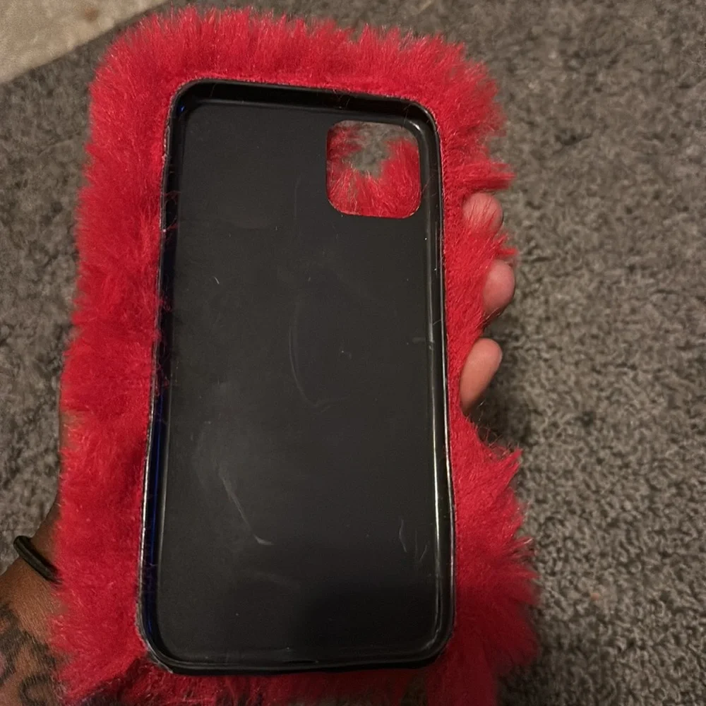This is a fuzzy red case for a iPhone 11 pro max. There is a few little scratch. - Picture 2 of 4